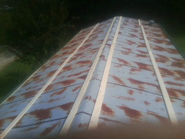 Rusted metal roof panels with new wood purlins before replacement — Storm Damage Roof Repair in Brackenridge by Roofing Brothers
